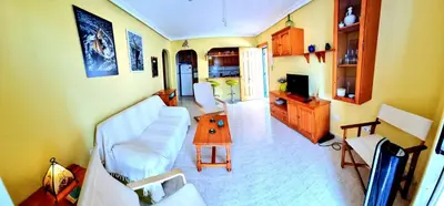 Una televisión o centro de entretenimiento en Apartamento 1 dormitorio VERAMAR 1 2ª línea de playa