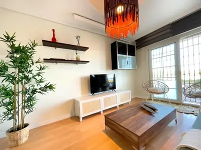 Una televisión o centro de entretenimiento en KS Golf Playa - Kaleria Suites