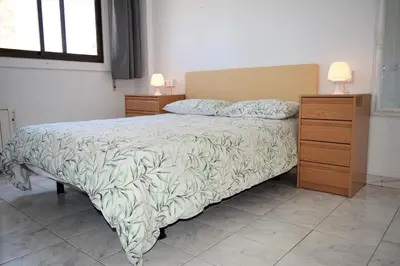 Cama o camas de una habitación en Luminoso apartamento que tiene amplia terraza, gran piscina y a 4 min de la playa