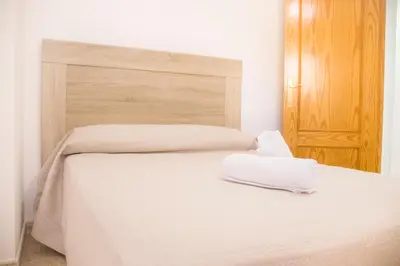 Cama o camas de una habitación en Apartamentos Luna de Águilas