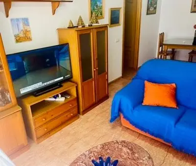Una televisión o centro de entretenimiento en Castillo Suites, Vivienda con Fines Turísticos El Castillo de Roquetas