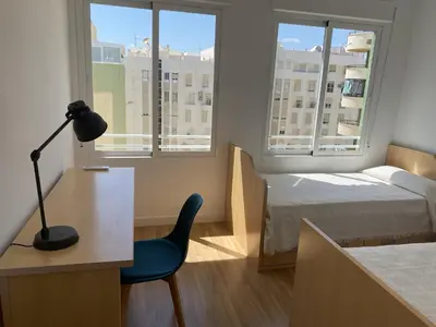 Cama o camas de una habitación en DELICIAS PLAYA, frente al mar con parking incluido