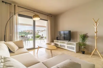 Una televisión o centro de entretenimiento en Vera Golf Los Dos Soles Bajo Jardín Piscina Wifi