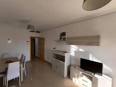 Una televisión o centro de entretenimiento en APARTAMENTOS TURISTICOS 4ºD CARLOS III - Cerca de la playa