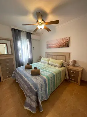 Cama o camas de una habitación en EL ESCONDITE Bahía de Vera Naturista