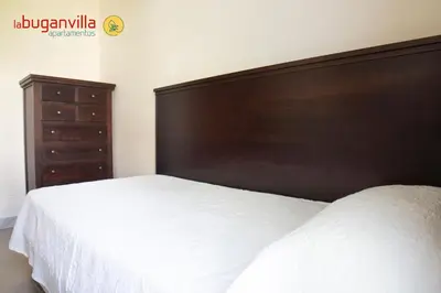 Cama o camas de una habitación en Apartamentos la Buganvilla