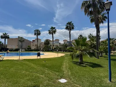 Piscina en o cerca de Apartamento TorreMar Natura Urbanización Naturista, Piscina Climatizada, Bajo con Jardín, Parking