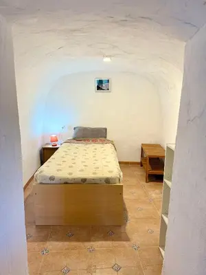 Cama o camas de una habitación en Cortijo Maya, maison troglodyte pour 10 personnes