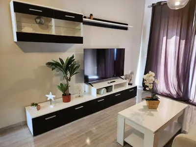 Una televisión o centro de entretenimiento en Ático Boutique con Piscina privada en el Solárium y Diseño Natural