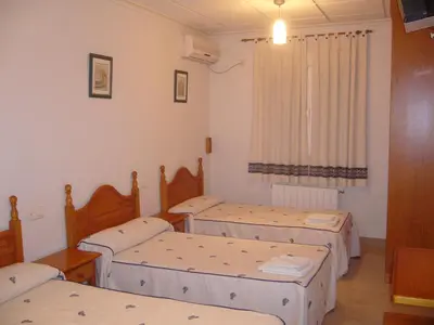 Cama o camas de una habitación en Hostal Casa Grande