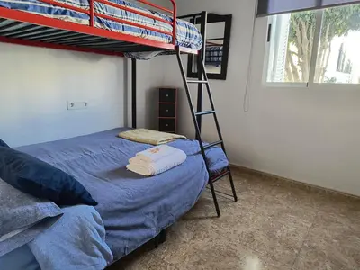 Cama o camas de una habitación en apartamento en Vera Playa con piscina privada