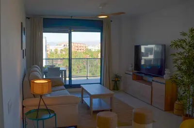 Una televisión o centro de entretenimiento en TrendyHomes Almerimar Beach II, residencial de lujo en primera línea de playa