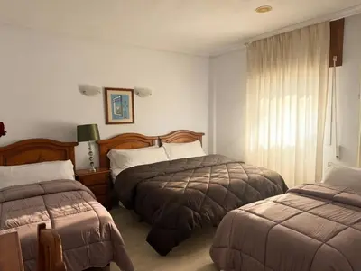 Cama o camas de una habitación en Hotel Mesón el 21