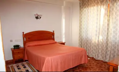 Cama o camas de una habitación en Hotel Los Arcos