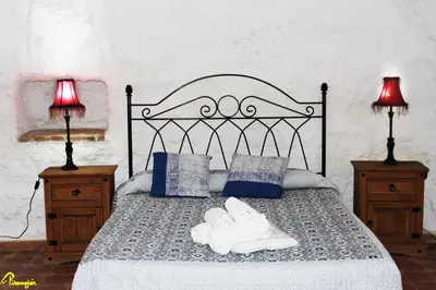 Cama o camas de una habitación en Alojamientos Cuevas Pinomojon