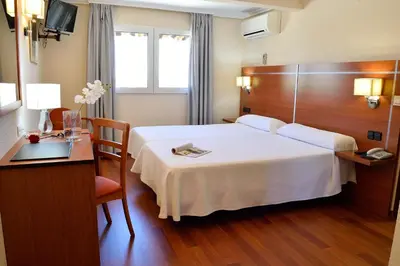 Cama o camas de una habitación en Hotel Mari Carmen