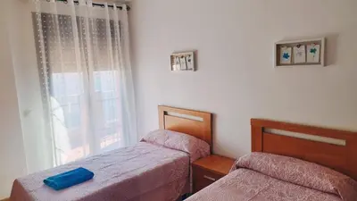Cama o camas de una habitación en Apartamentos Turísticos Edificio del Pino