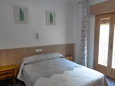 Cama o camas de una habitación en Apartamentos Casa FERMINA - A 2 horas de las pistas de esquí