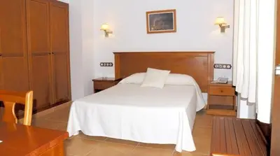Cama o camas de una habitación en Hotel Donde Caparrós