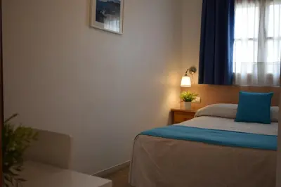 Cama o camas de una habitación en Hostales Juan de Austria I & II