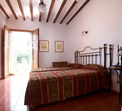 Cama o camas de una habitación en Hotel Casa de los Arcos