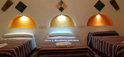 Cama o camas de una habitación en Cuevas Lourdes