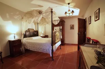 Cama o camas de una habitación en Palacete Magistral Domínguez habitaciones