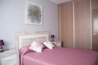Cama o camas de una habitación en Apartamentos EL POSAERO Juan Mariano