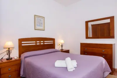 Cama o camas de una habitación en Apartamentos Sol Andaluz