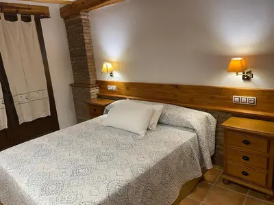 Cama o camas de una habitación en Alhanda Apartahotel