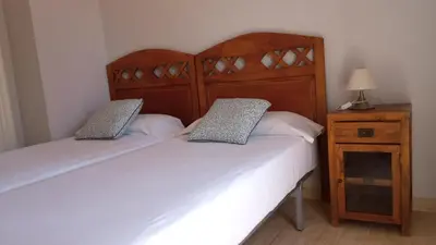 Cama o camas de una habitación en Habitaciones Jacaranda