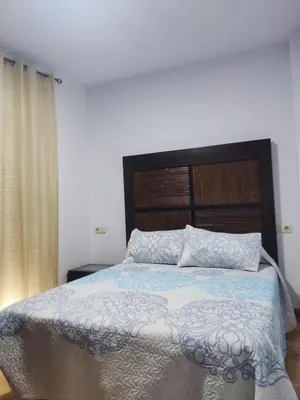 Cama o camas de una habitación en Apartamentos a 300 metros playa