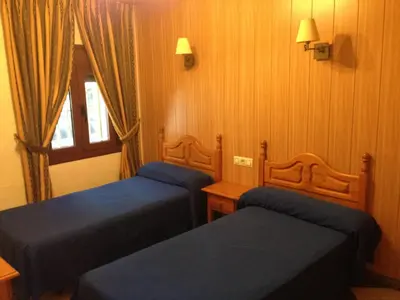 Cama o camas de una habitación en Hostal Delfin Verde