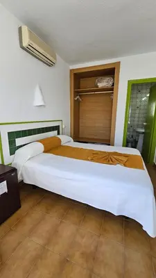 Cama o camas de una habitación en Hotel El Puntazo I