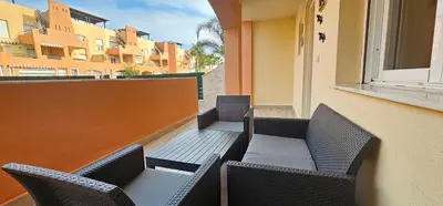 Zona de estar de Homes of Spain, Apartamentos Paraiso de Vera Playa, Ed Tahiti bajo F a pie de la playa, vistas piscina